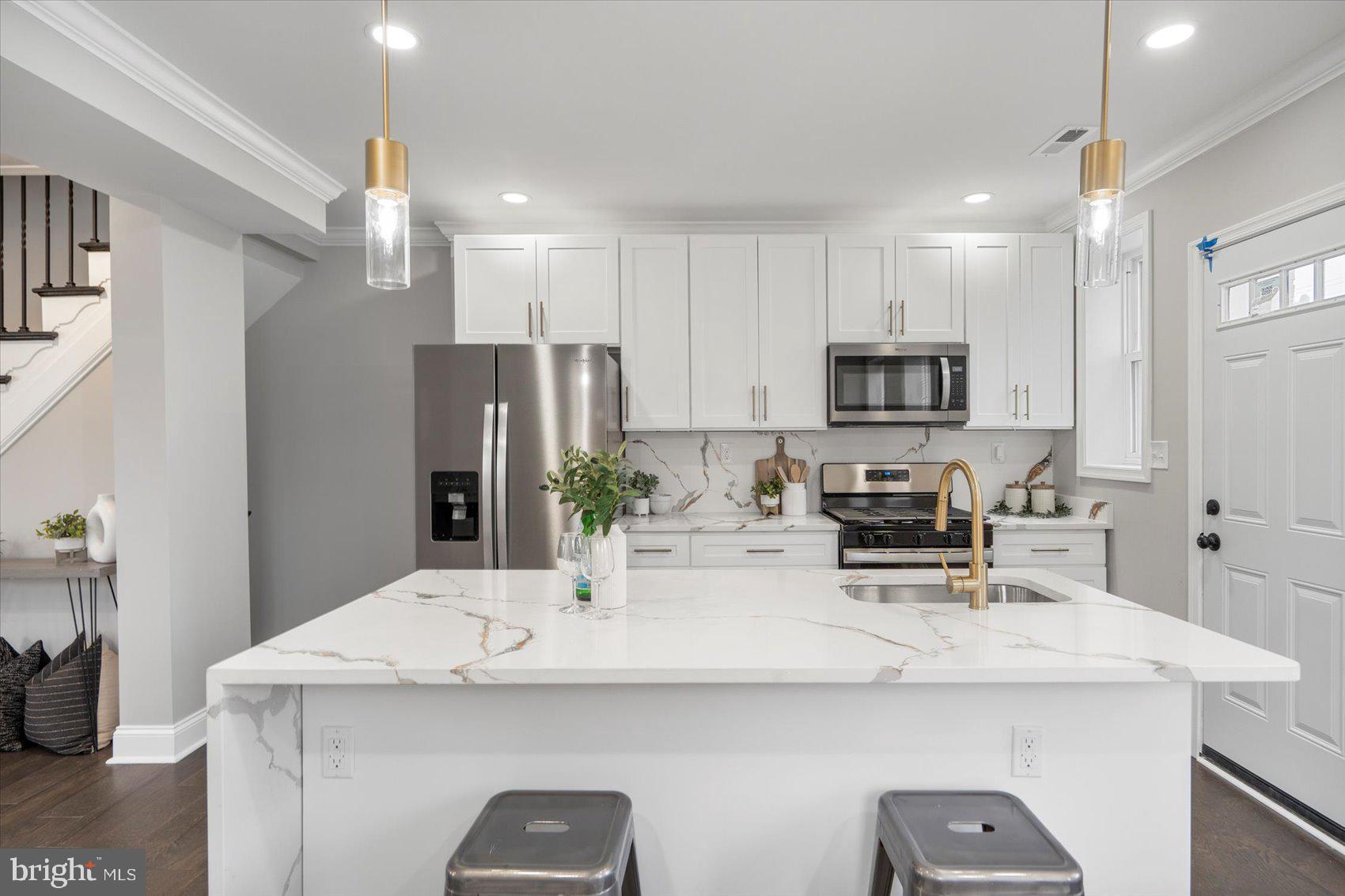 2901 Edison Highway Baltimore, MD 21213 - Photo 14 of 52 a kitchen with kitchen island a counter top space appliances and cabinets