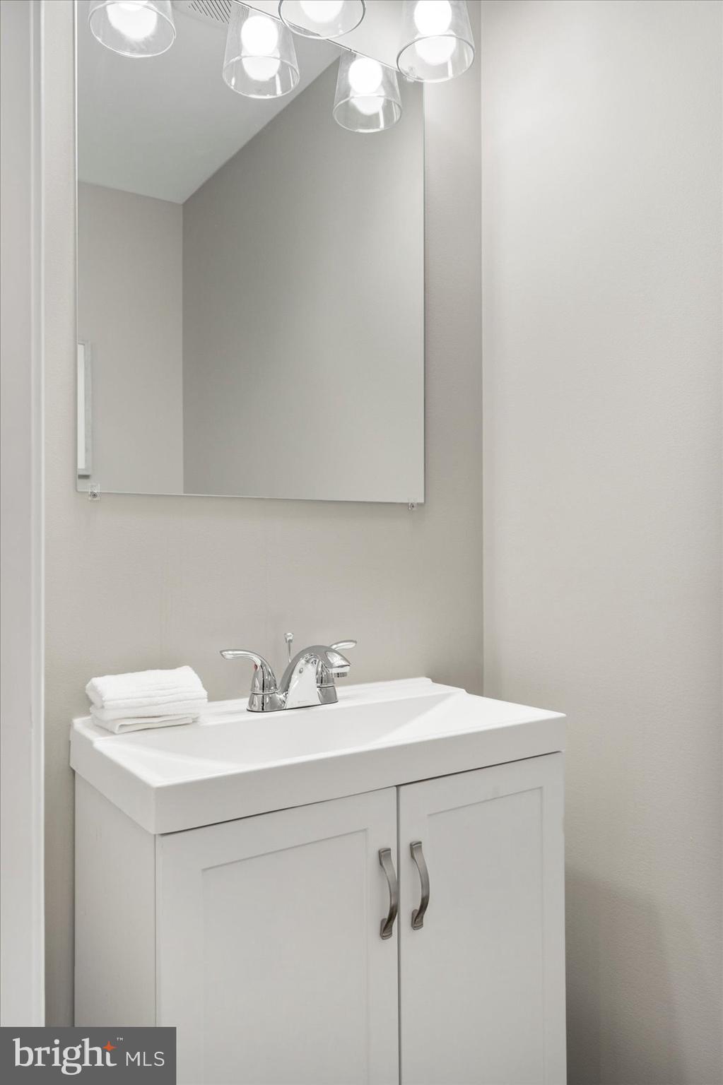 2901 Edison Highway Baltimore, MD 21213 - Photo 17 of 52 a bathroom with a sink and a mirror