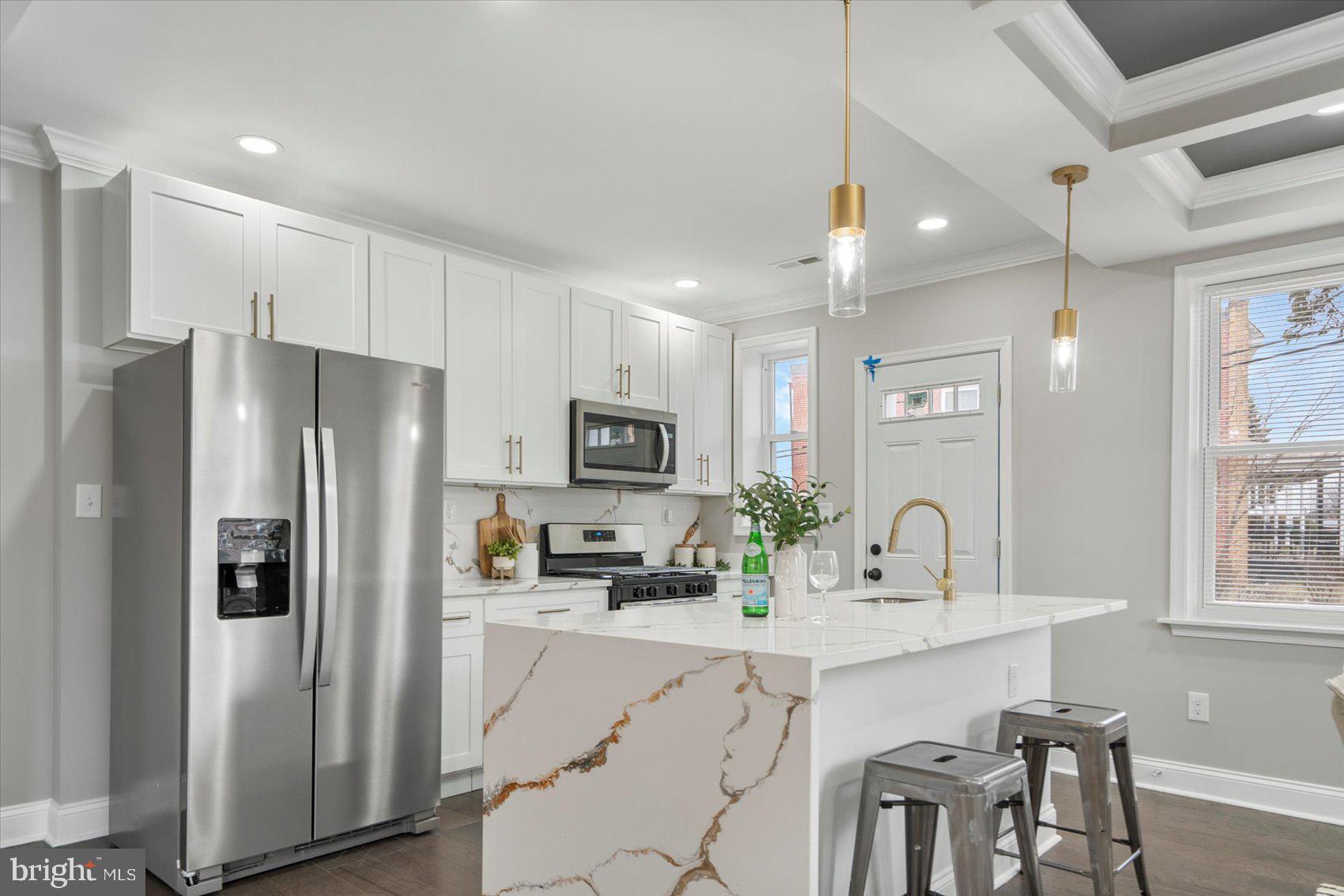 2901 Edison Highway Baltimore, MD 21213 - Photo 21 of 52 a kitchen with refrigerator a sink and chairs