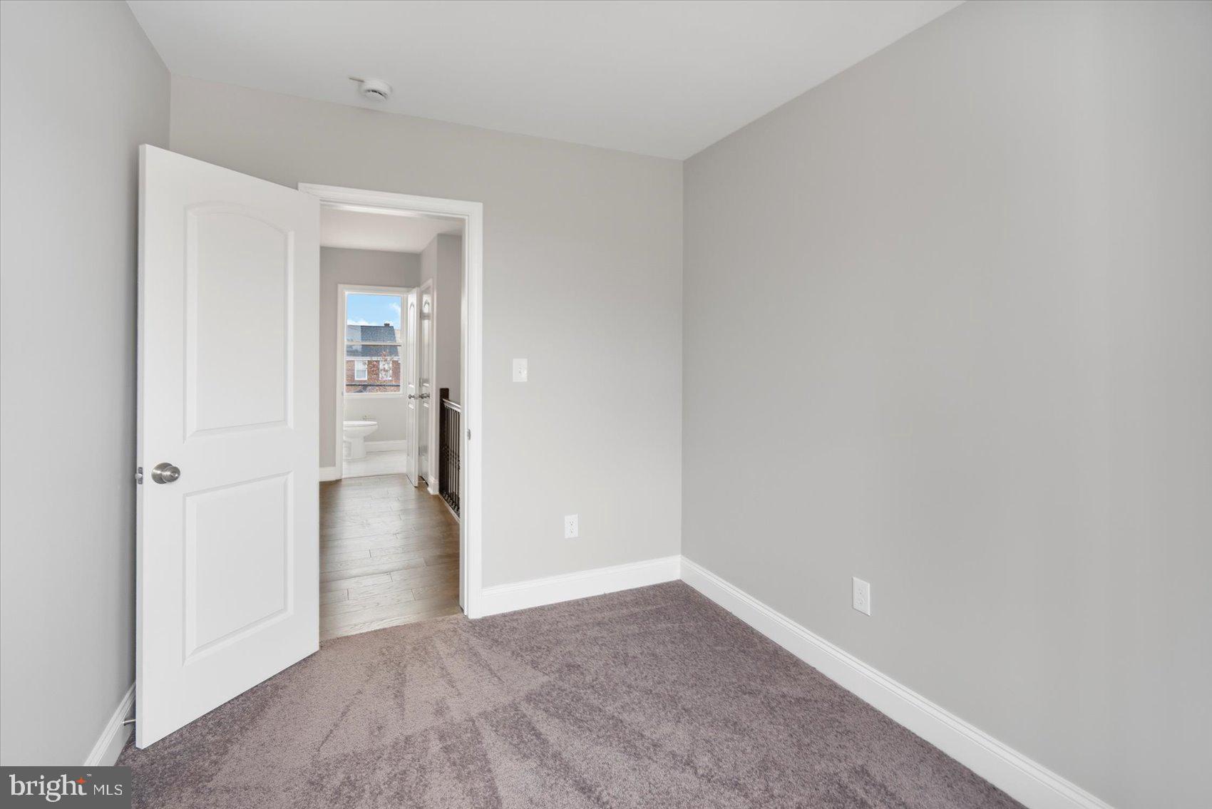 2901 Edison Highway Baltimore, MD 21213 - Photo 33 of 52 wooden floor in a hall with an empty room