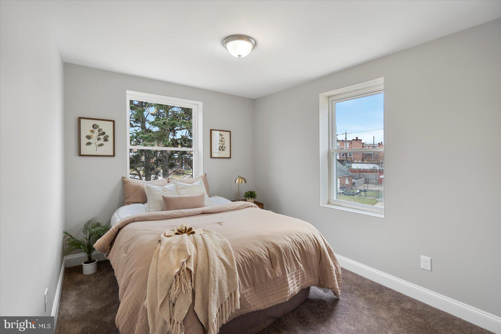 2901 Edison Highway Baltimore, MD 21213 - Photo 35 of 52 a bed sitting in a bedroom next to a window