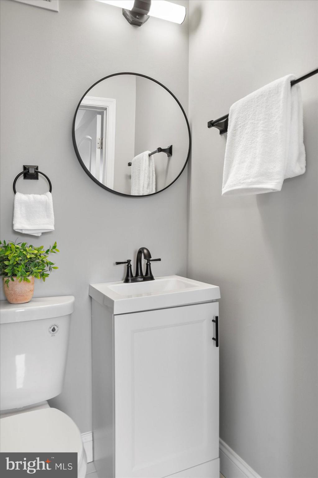 2901 Edison Highway Baltimore, MD 21213 - Photo 41 of 52 a bathroom with a sink a toilet and a mirror