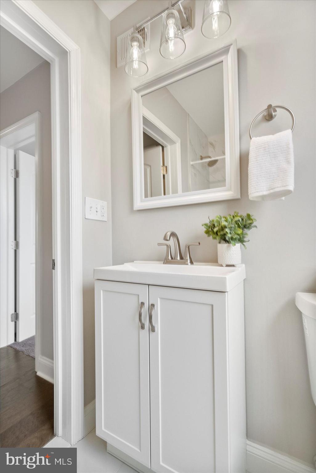 2901 Edison Highway Baltimore, MD 21213 - Photo 44 of 52 a bathroom with a sink a mirror and a vanity
