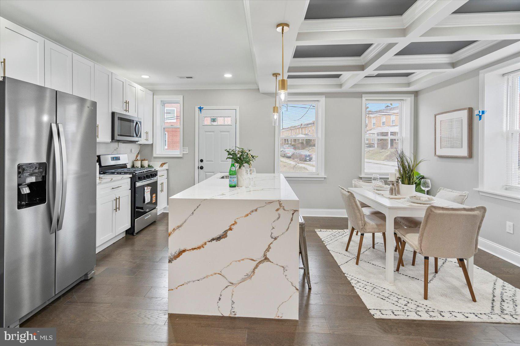 2901 Edison Highway Baltimore, MD 21213 - Photo 8 of 52 a kitchen with stainless steel appliances kitchen island granite countertop a table chairs stove and refrigerator