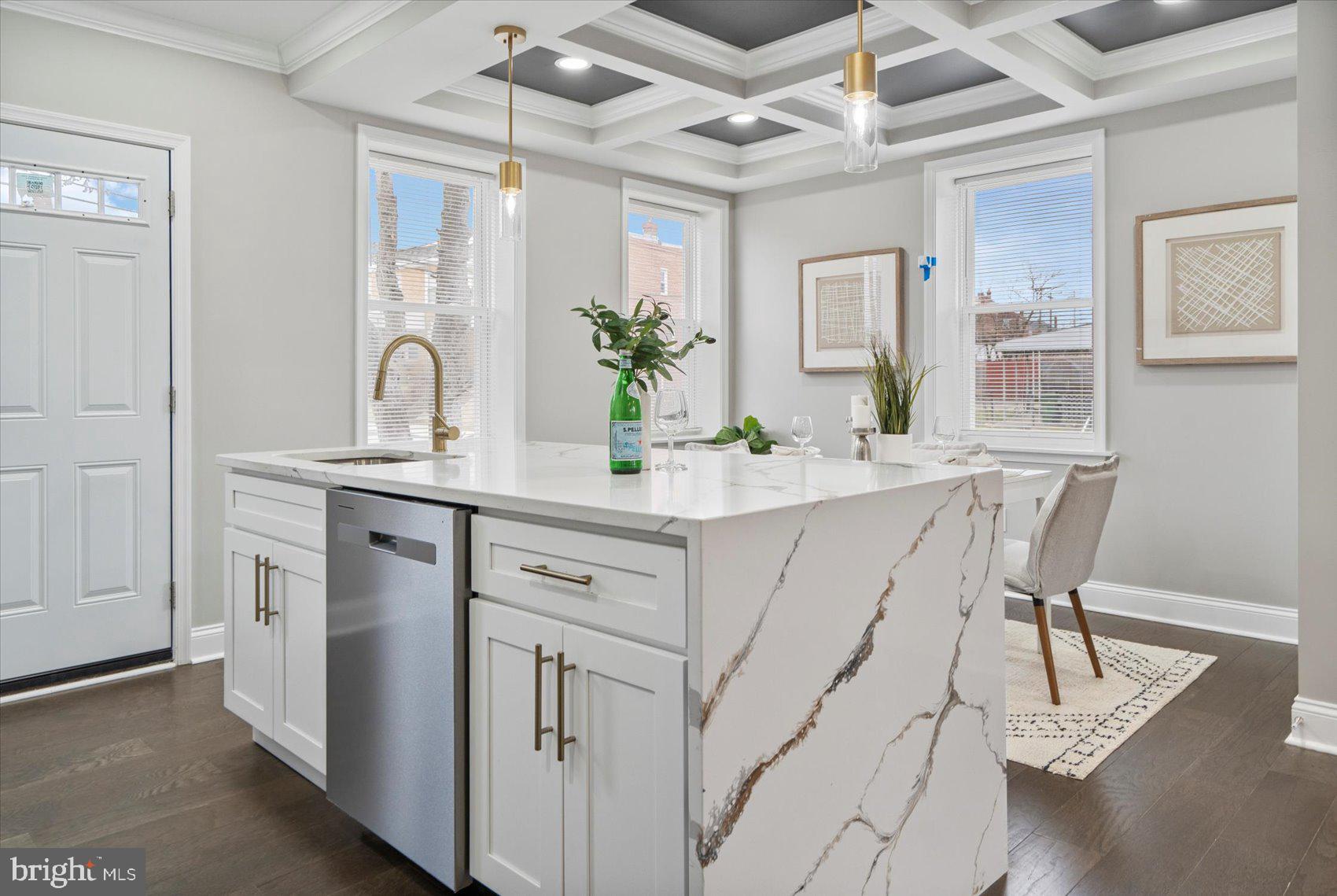2901 Edison Highway Baltimore, MD 21213 - Photo 9 of 52 a dining hall with stainless steel appliances kitchen island granite countertop a table chairs in it and wooden floor