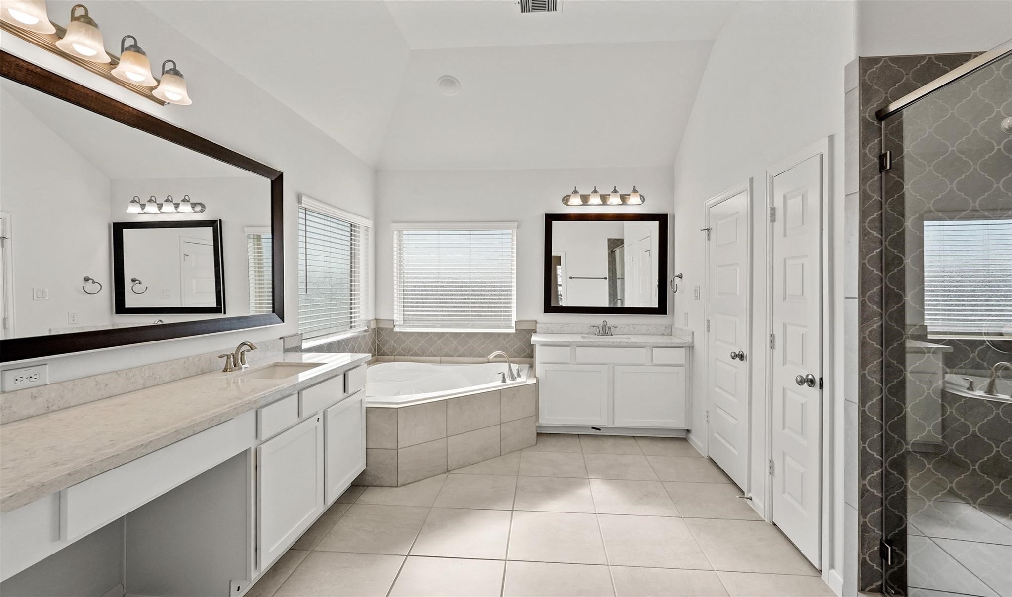 10609 Centre Green Way Houston, TX 77043 - Photo 13 of 27 a spacious bathroom with a double vanity sink mirror and bathtub