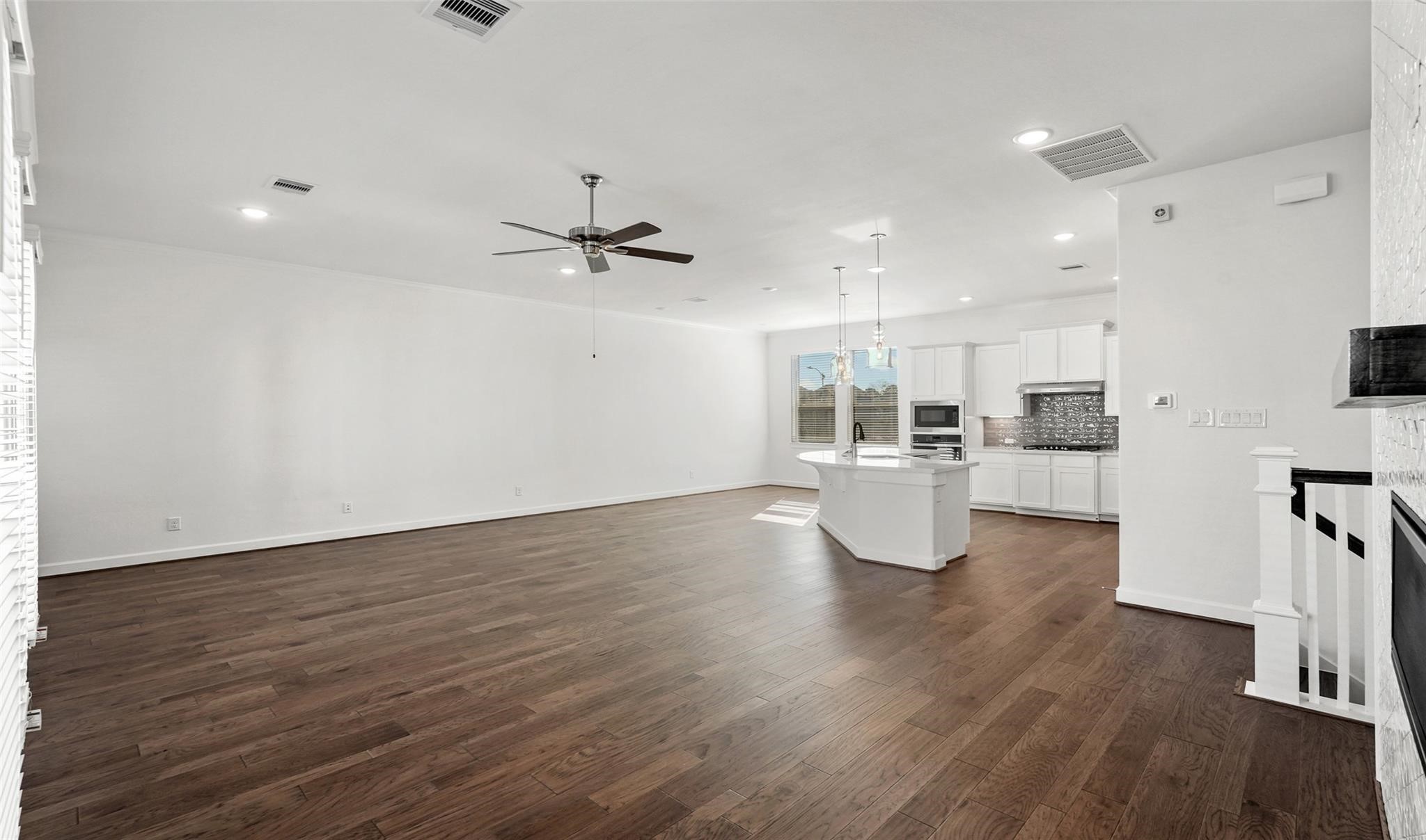 10609 Centre Green Way Houston, TX 77043 - Photo 8 of 27 a view of a kitchen with furniture and wooden floor