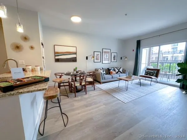 a living room with furniture and a large window