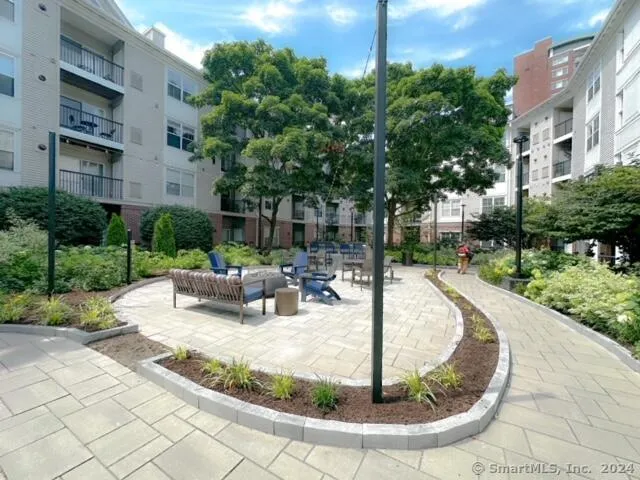 a bedroom with a bed a mirror on dresser and a window