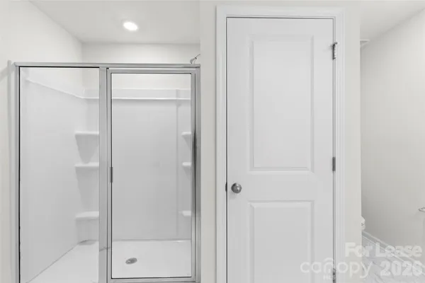 a bathroom with a glass shower door
