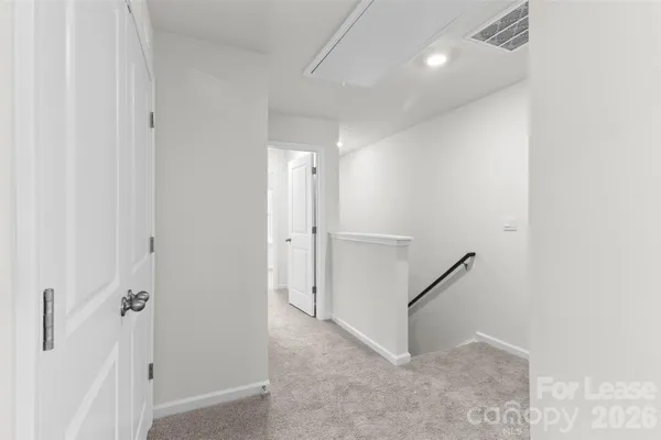 a view of a hallway with staircase