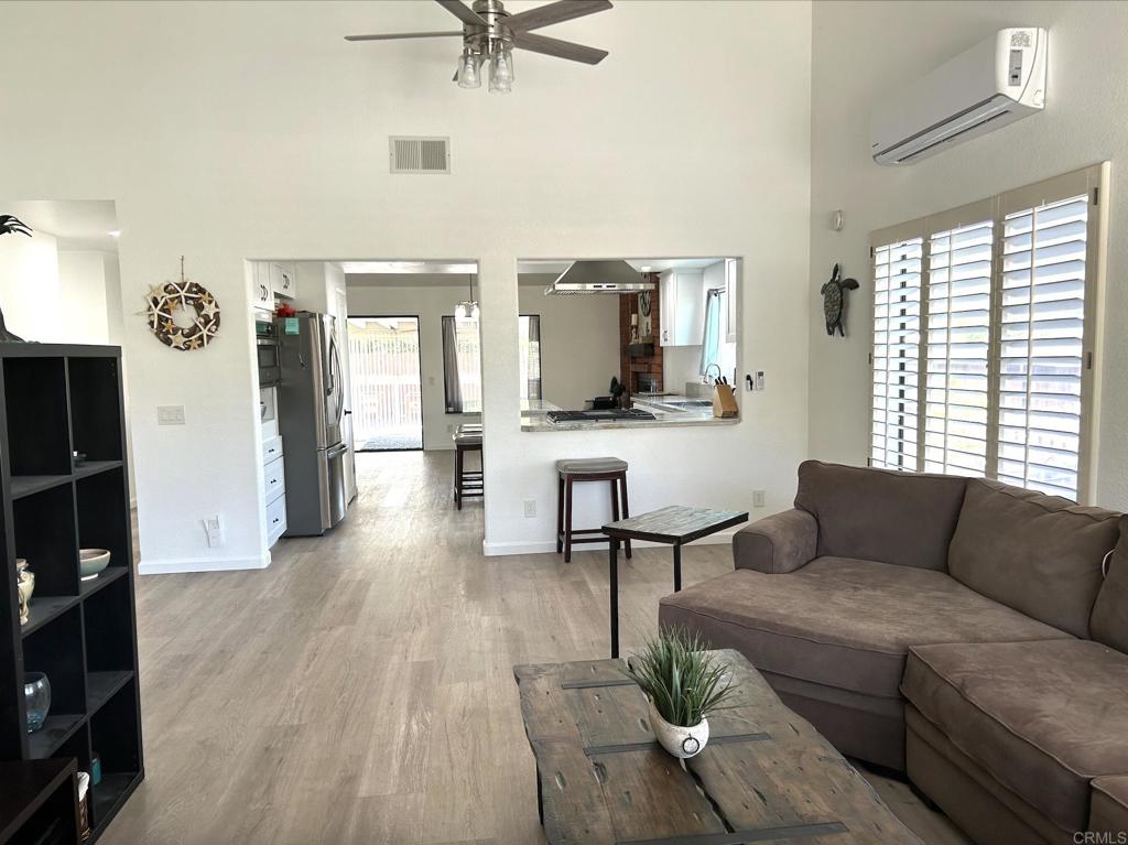 3594 Newland Road Oceanside, CA 92056 - Photo 11 of 44 a living room with furniture and wooden floor