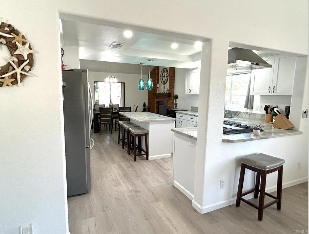 3594 Newland Road Oceanside, CA 92056 - Photo 12 of 44 a kitchen with a table chairs refrigerator and cabinets