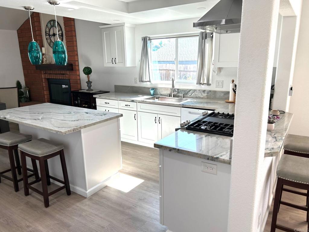 3594 Newland Road Oceanside, CA 92056 - Photo 13 of 44 a kitchen with a stove a sink and a refrigerator