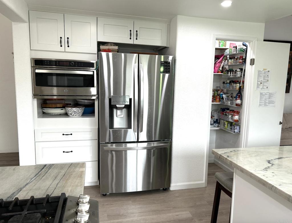 3594 Newland Road Oceanside, CA 92056 - Photo 14 of 44 a kitchen with granite countertop a refrigerator and a sink