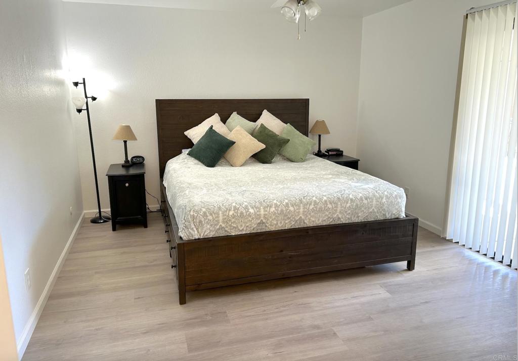 3594 Newland Road Oceanside, CA 92056 - Photo 24 of 44 a bed sitting in a bedroom next to a window and a wooden floor