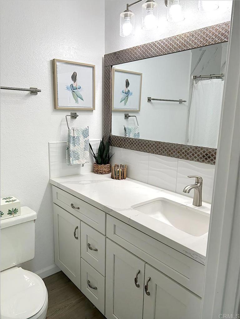 3594 Newland Road Oceanside, CA 92056 - Photo 34 of 44 a bathroom with a granite countertop sink mirror and toilet