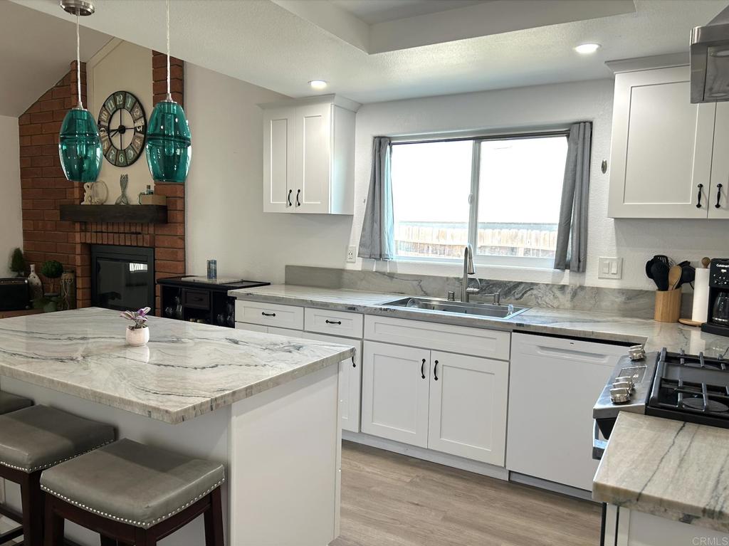 3594 Newland Road Oceanside, CA 92056 - Photo 5 of 44 a kitchen with a sink a window and cabinets