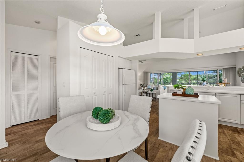 13100 Hamilton Harbour Drive, Unit G11 Naples, FL 34110 - Photo 14 of 32 a kitchen with a table and chairs