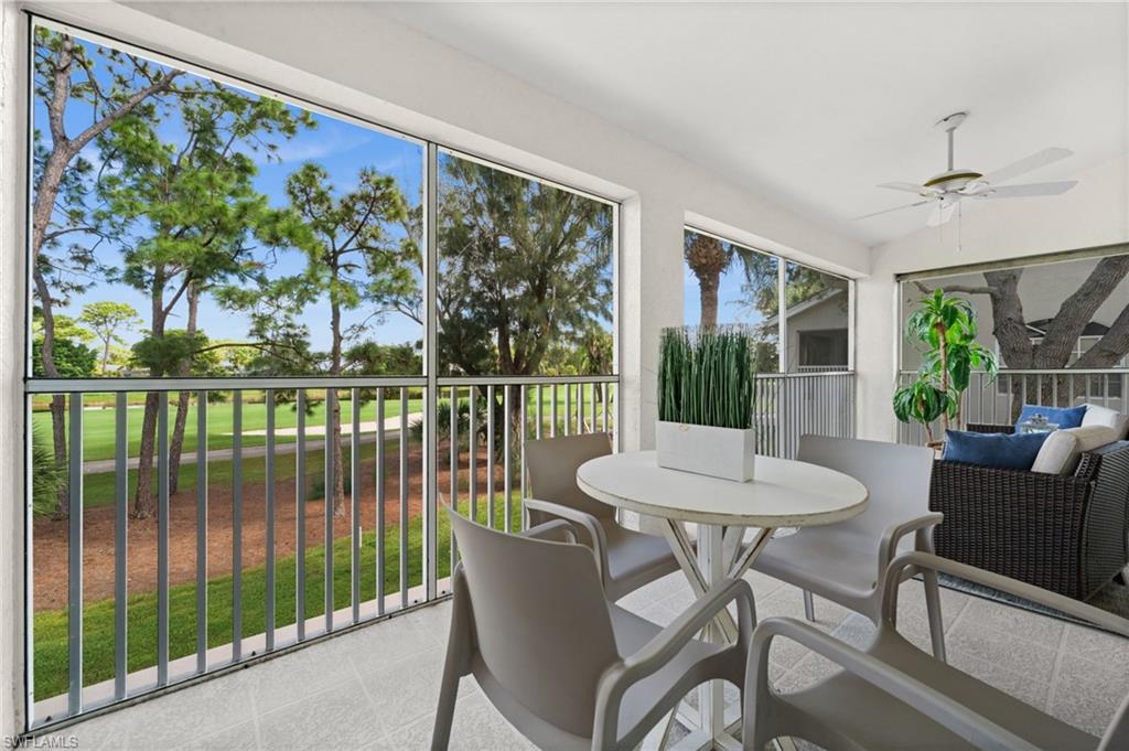 13100 Hamilton Harbour Drive, Unit G11 Naples, FL 34110 - Photo 17 of 32 a dining room with furniture a rug and a floor to ceiling window