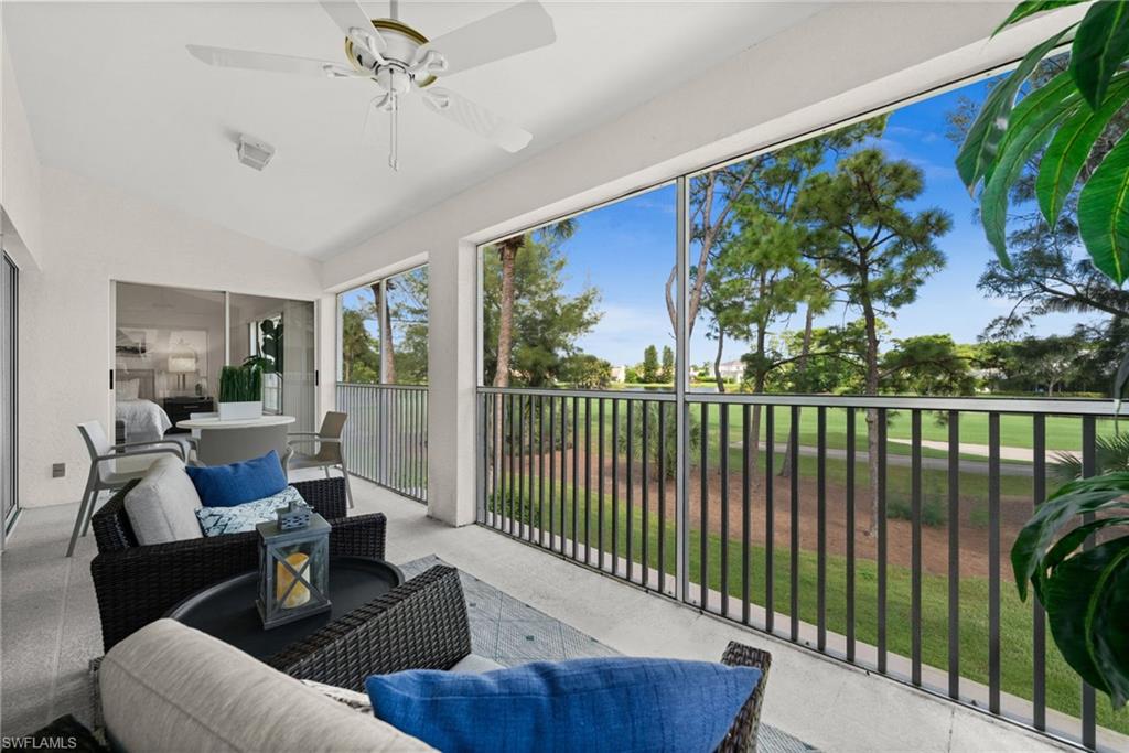 13100 Hamilton Harbour Drive, Unit G11 Naples, FL 34110 - Photo 18 of 32 a living room with furniture tv and a large window