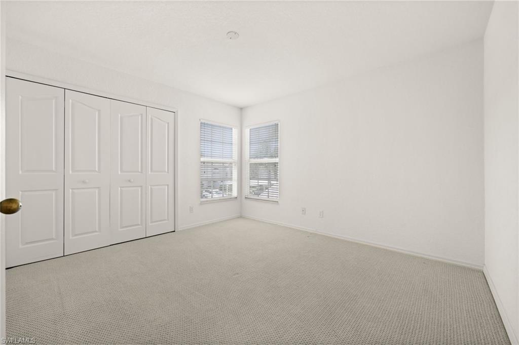 13100 Hamilton Harbour Drive, Unit G11 Naples, FL 34110 - Photo 24 of 32 an empty room with windows