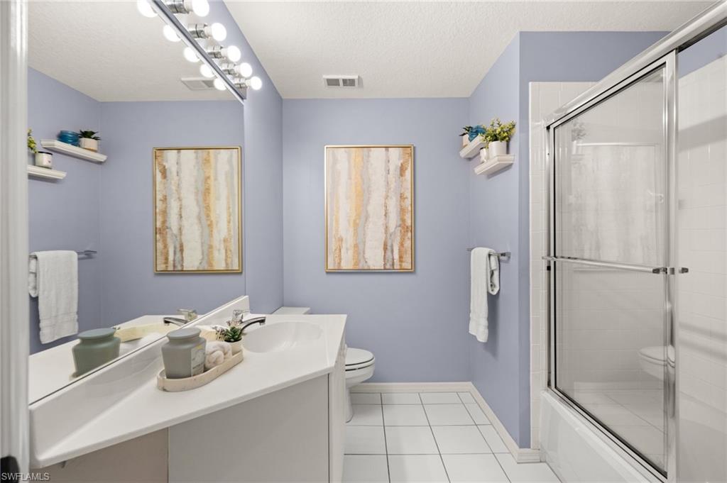 13100 Hamilton Harbour Drive, Unit G11 Naples, FL 34110 - Photo 26 of 32 a bathroom with a sink toilet and shower