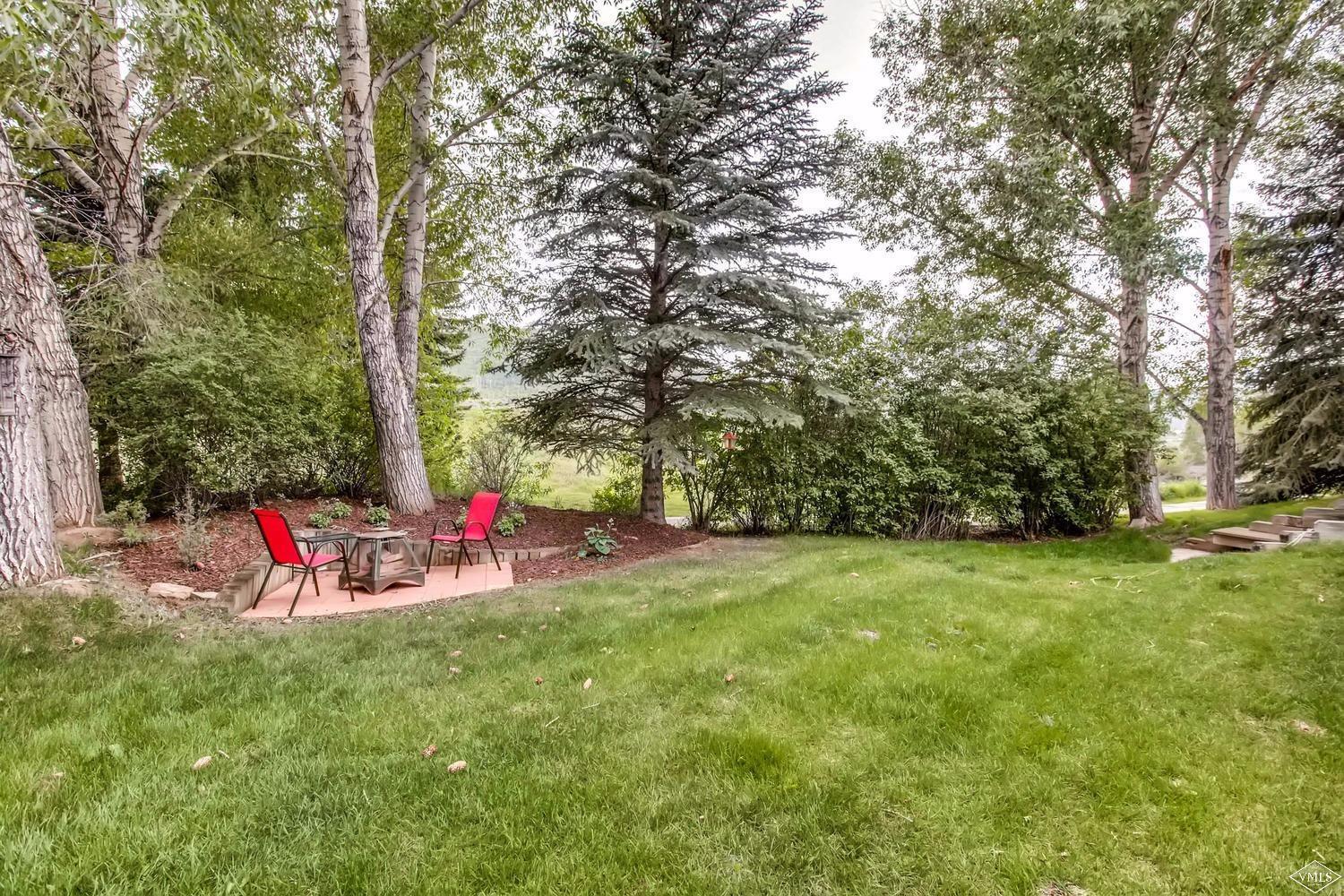 325 Rawhide Road Edwards, CO 81632 - Photo 21 of 23 Fire pit in backyard with mature trees.