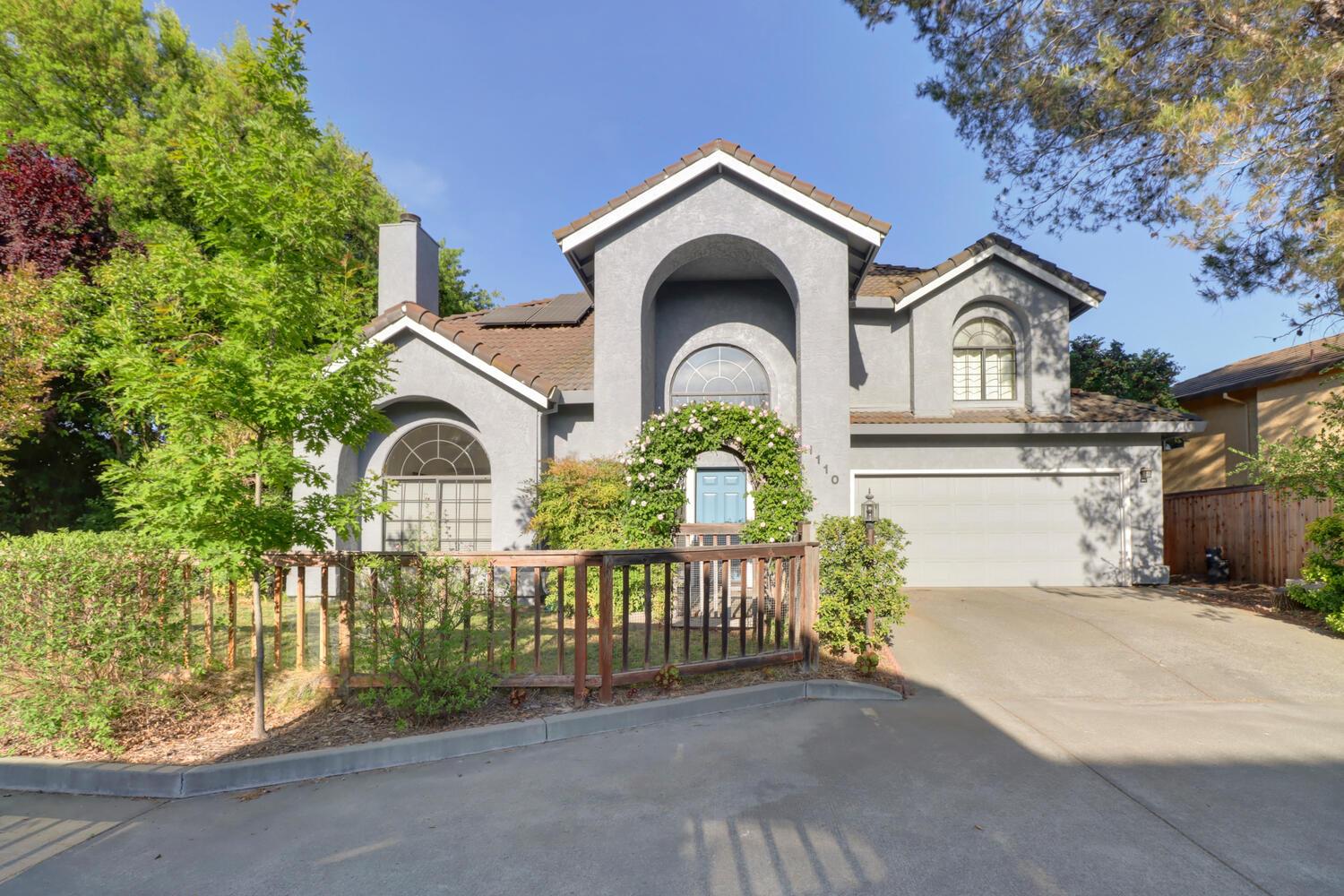 a front view of a house with a garden