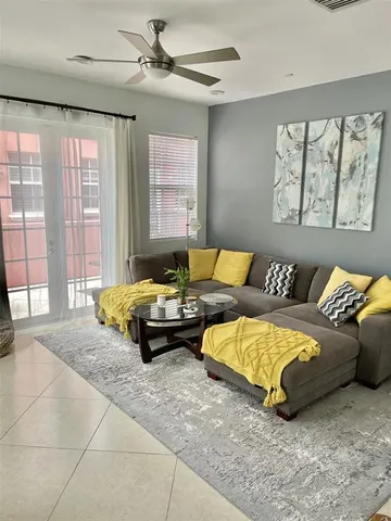 a living room with furniture and a large window