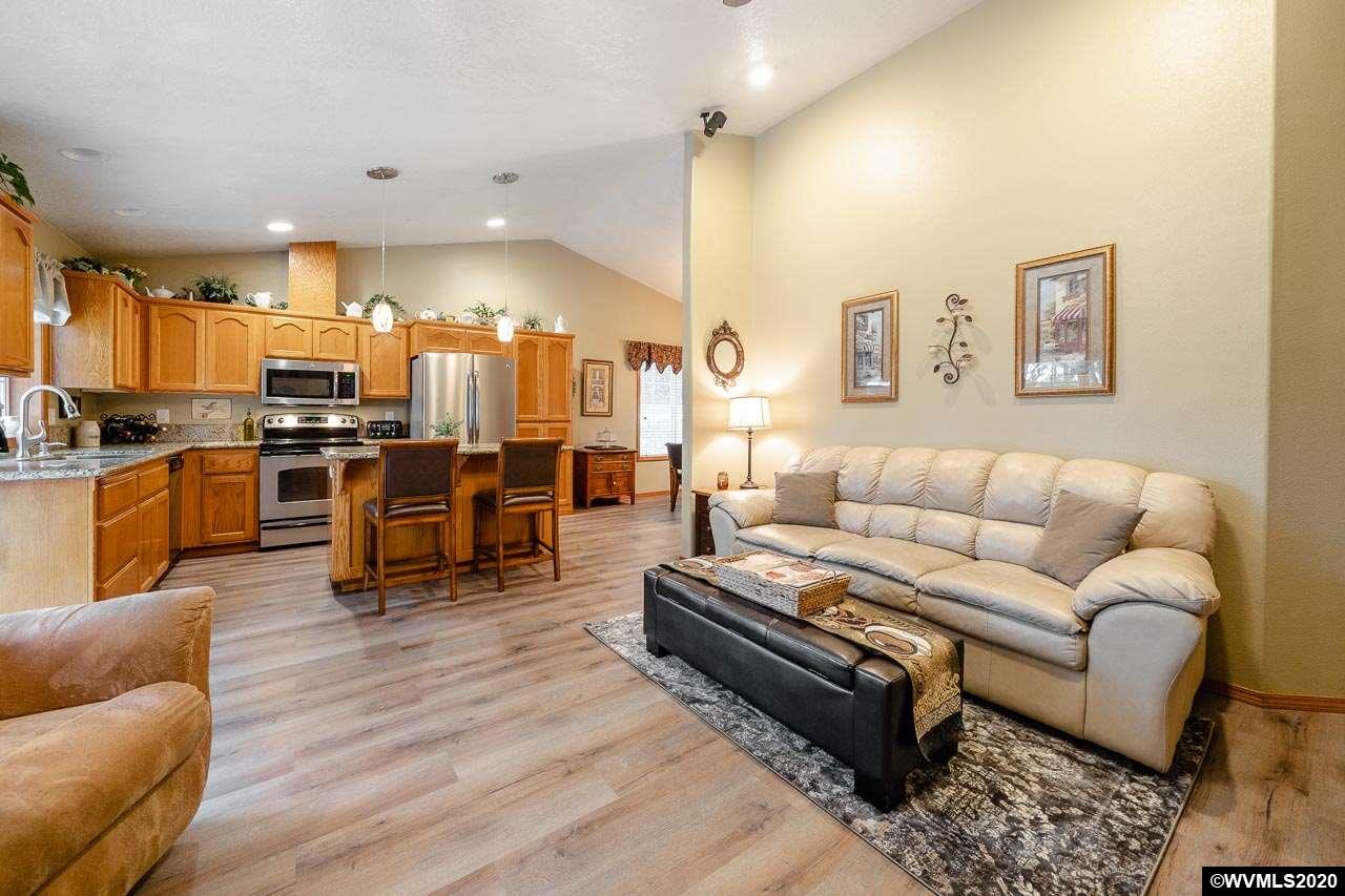 15241 Strong Road Dallas, OR 97338 - Photo 12 of 40 a living room with couches and kitchen view with wooden floor