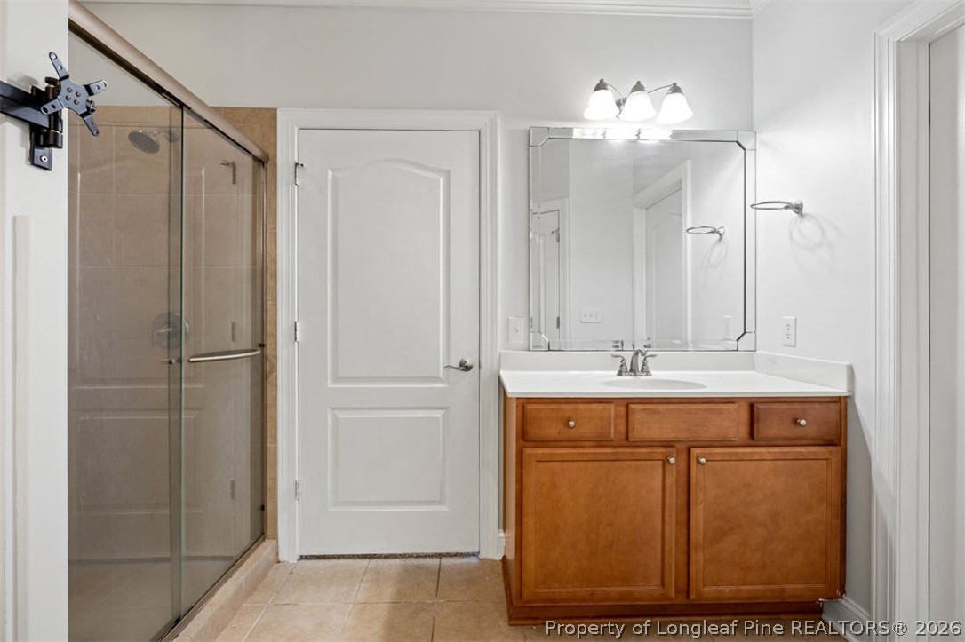 62 Gallery Drive, Unit 102 Spring Lake, NC 28390 - Photo 13 of 23 a bathroom with a double vanity sink mirror and shower