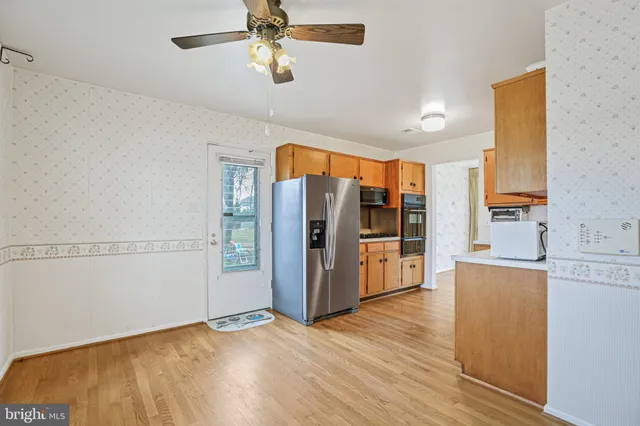 a view of a kitchen with refrigerator and cabinet