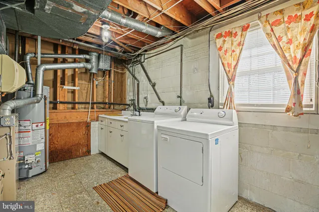 a view of empty room with wooden floor and fireplace