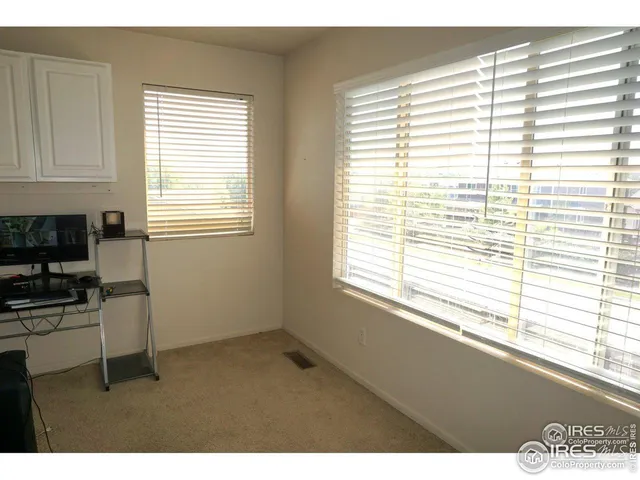 a living room with a couch and a bookshelf