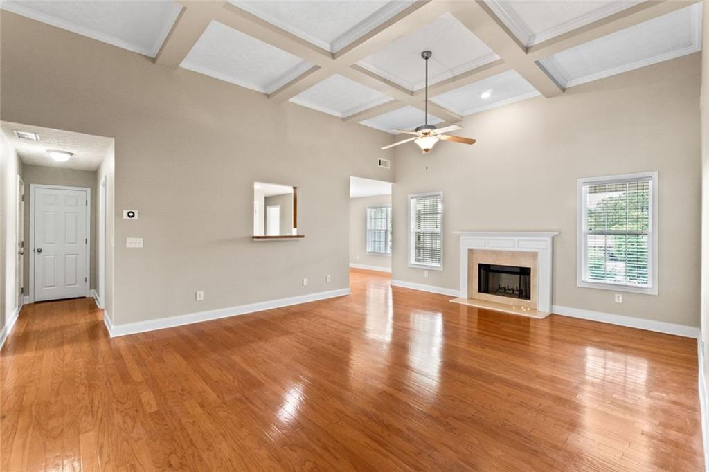 241 Red Bud Road Jefferson, GA 30549 - Photo 16 of 43 a view of empty room with wooden floor and fireplace