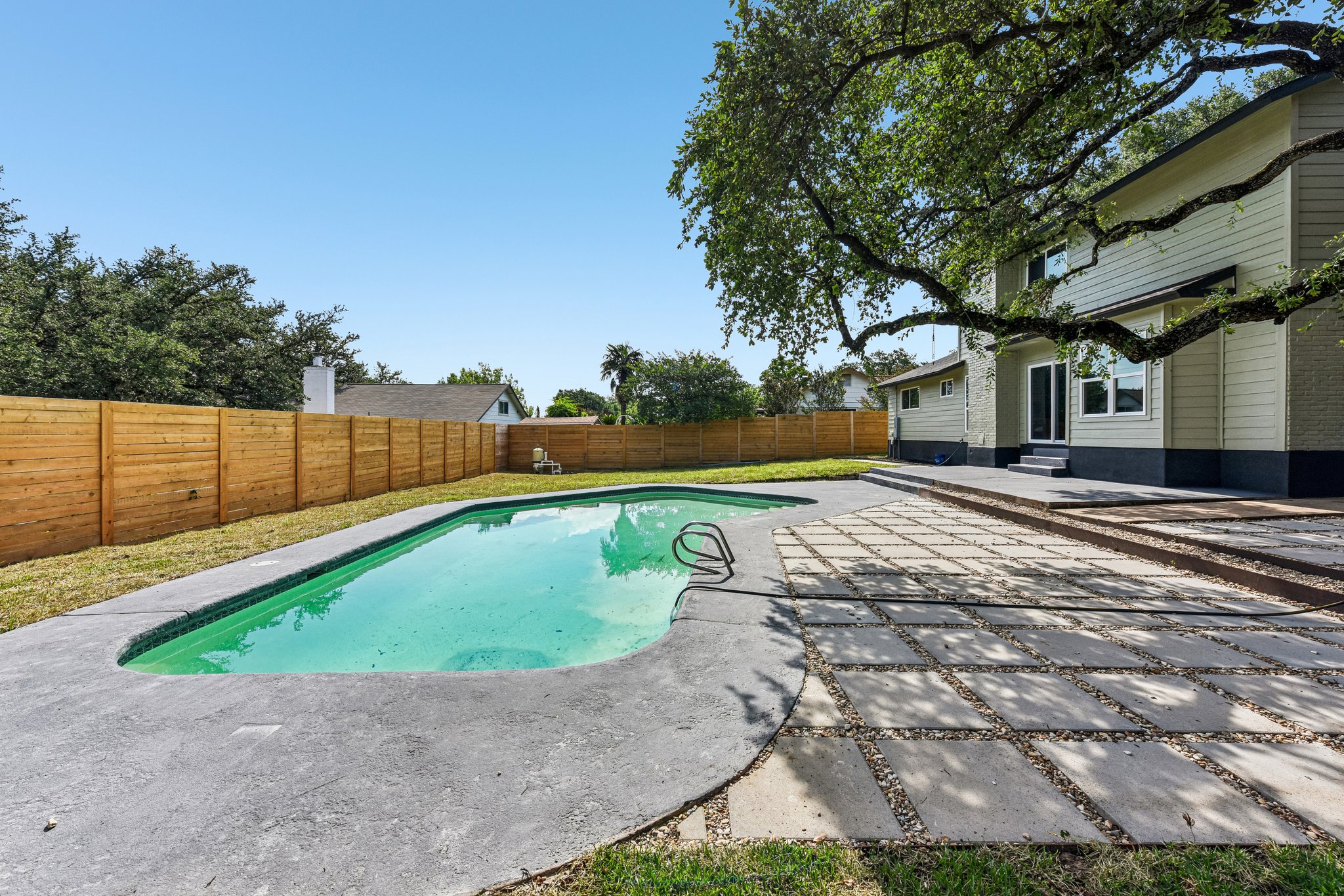 7523 Glenhill Road Austin, TX 78752 - Photo 32 of 38 A private swimming oasis awaits in this backyard, complemented by a serene patio space for outdoor enjoyment.