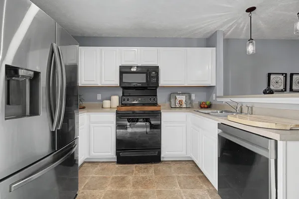 a kitchen with a refrigerator stove and sink