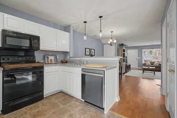 a kitchen with a stove oven and a refrigerator