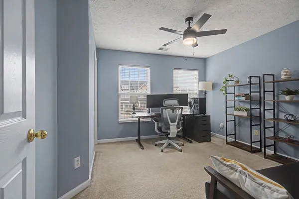 a view of a workspace with furniture
