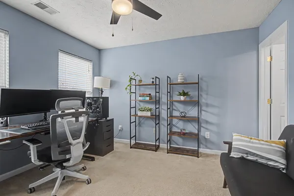 a view of a workspace with furniture