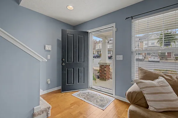 a living room with furniture and a floor to ceiling window
