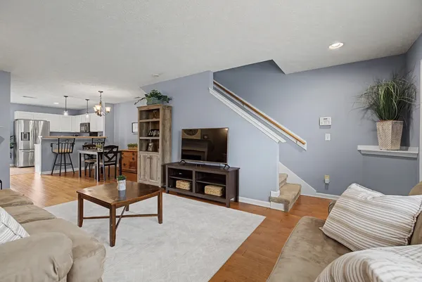 a living room with furniture and kitchen view