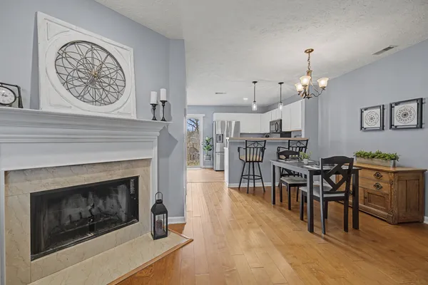 a living room with furniture a clock and a fireplace