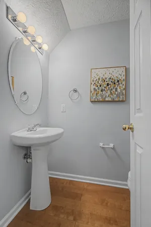 a bathroom with a sink a mirror and toilet
