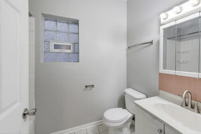 a white toilet sitting next to a bathroom sink