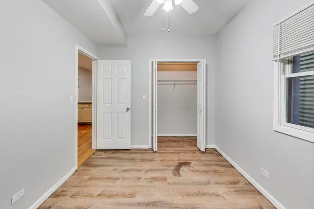 an empty room with closet and a window