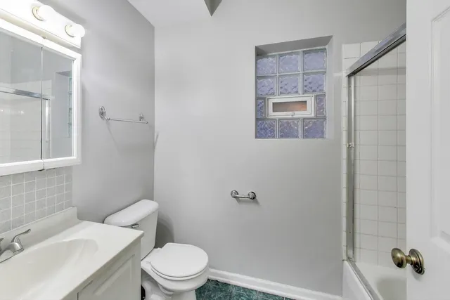 a white toilet sitting next to a bathroom sink