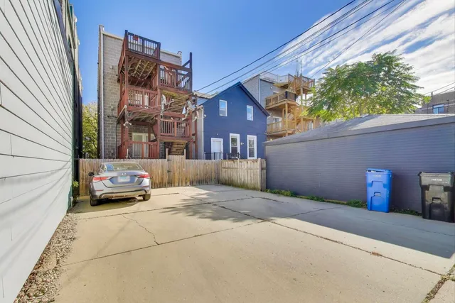 a front view of a house with cars