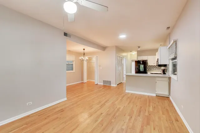 a view of kitchen with stainless steel appliances refrigerator oven and cabinets